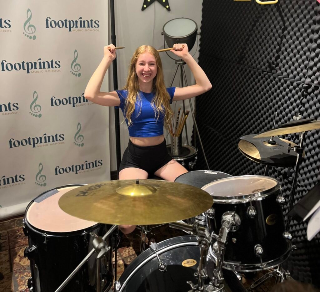 Girl Plays drum kit