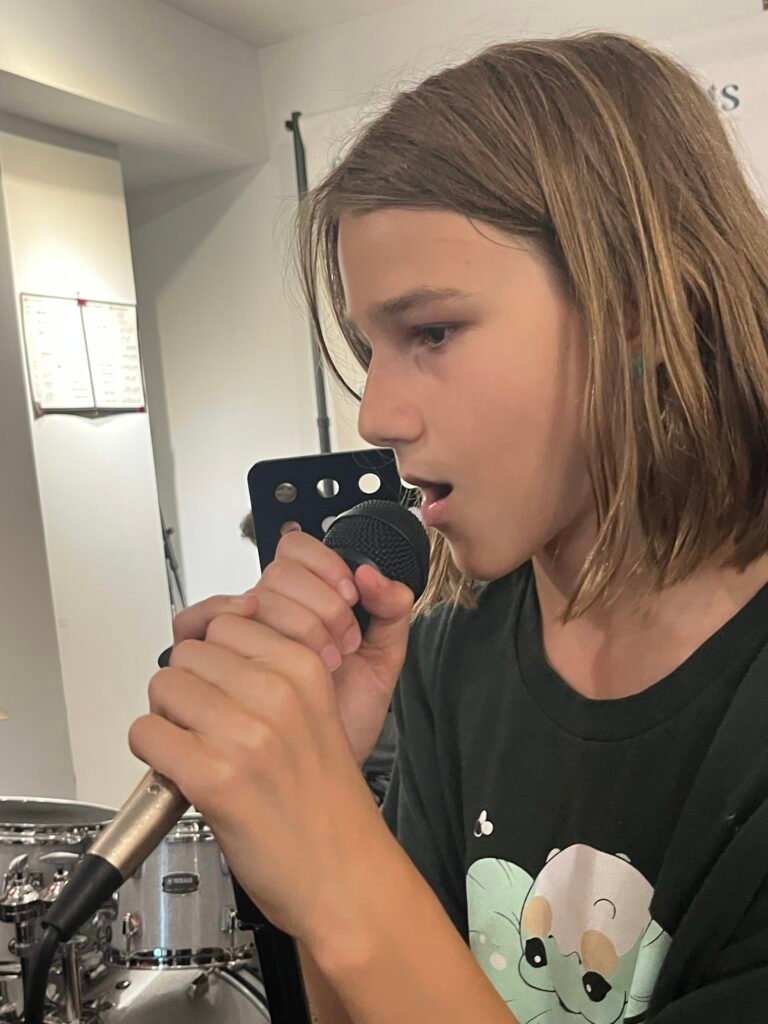 boy singing into a mic