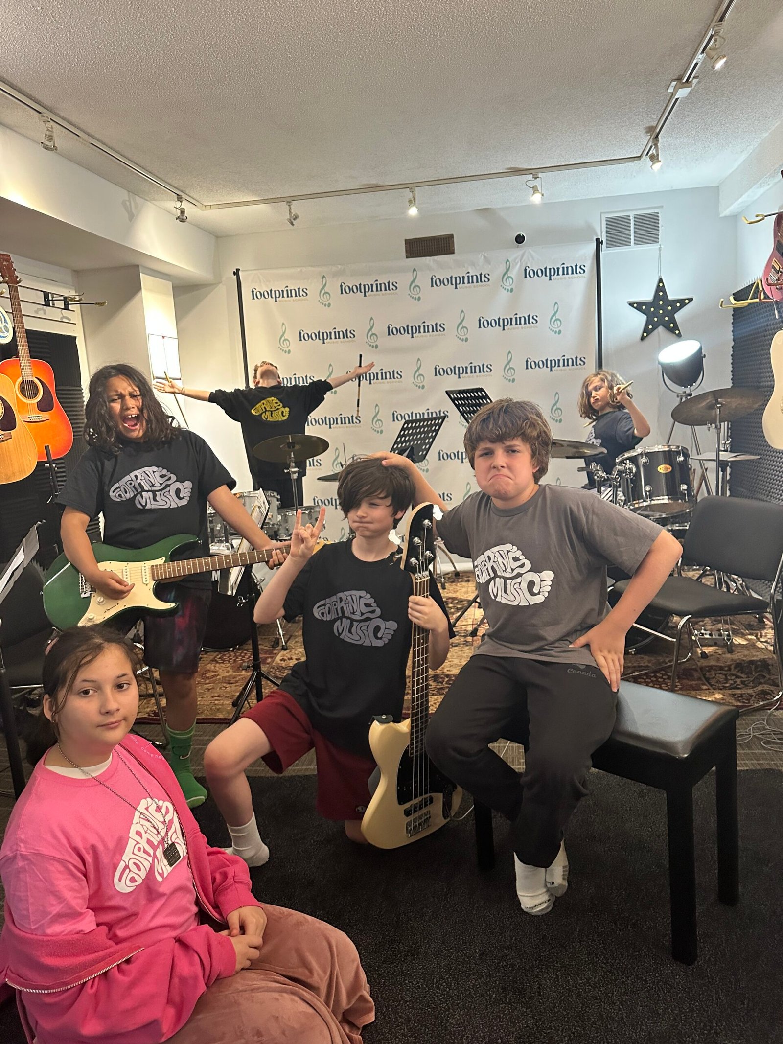 Kids playing together in a rock band at Footprints Music Summer Rock Camp