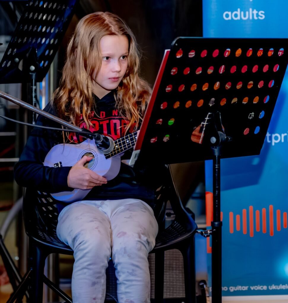 girl performs ukulele
